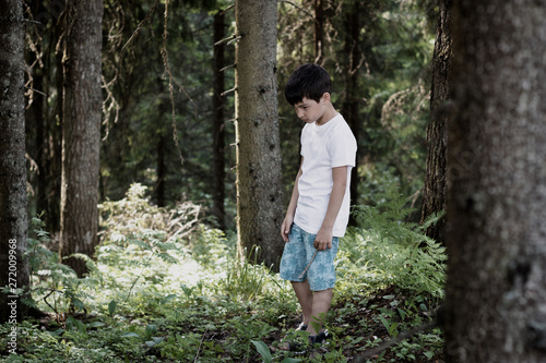 The child in the forest, escaped from the house and was lost, the heavy relations in family, trouble, disagreement, physical punishments, the concept of problems of the relation of adults and children © justoomm