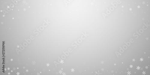 Sparse snowfall Christmas background. Subtle flying snow flakes and stars on light grey background. 