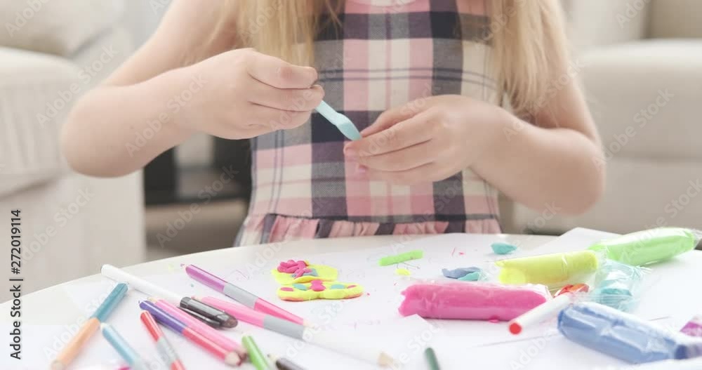 Hands of little girl molding colorful plasticine at home Hands of little girl molding colorful plasticine at home