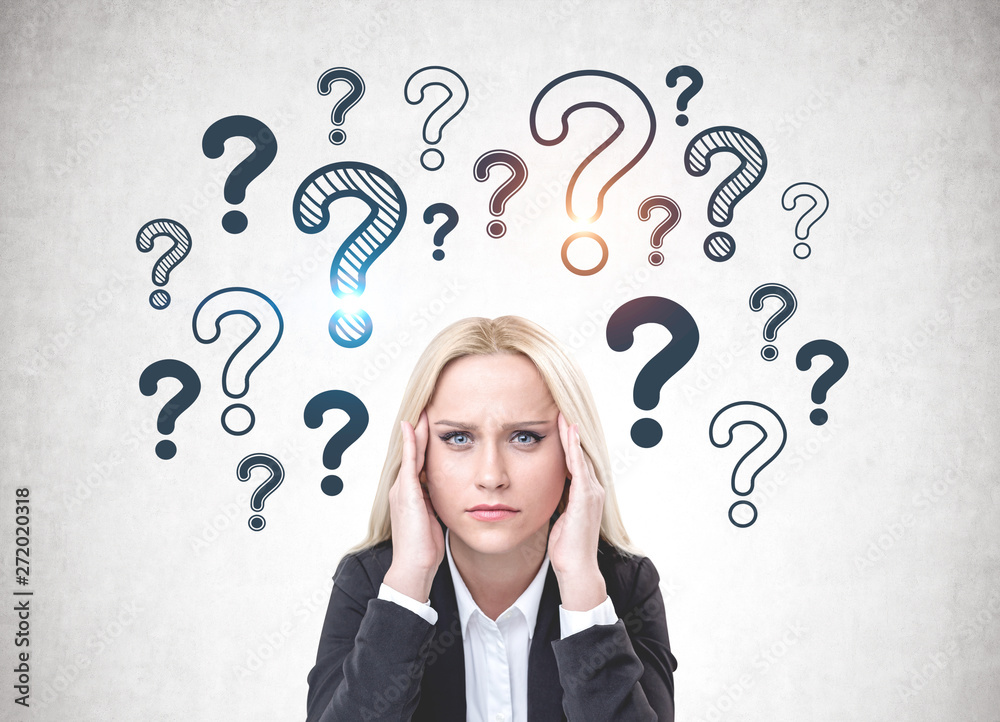 Stressed woman in suit, question marks Stressed woman in suit, question marks