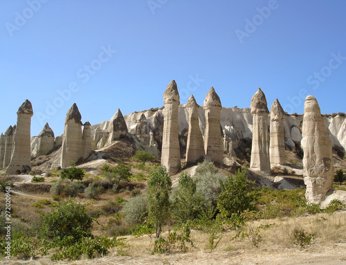 Stunning rock formations in Love Valley - one of the most popular tourist destinations in Cappadocia, Turkey. Bright sunny day in early autumn