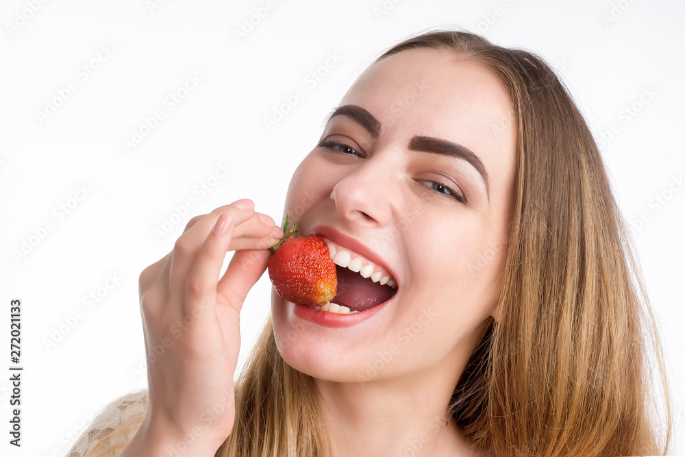 girl eagerly eating strawberries on white background. girl eagerly eating strawberries on white background.