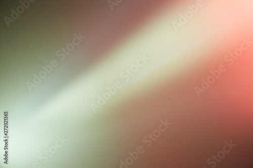 Diagonal ray of light on a pink dark pink and gray background