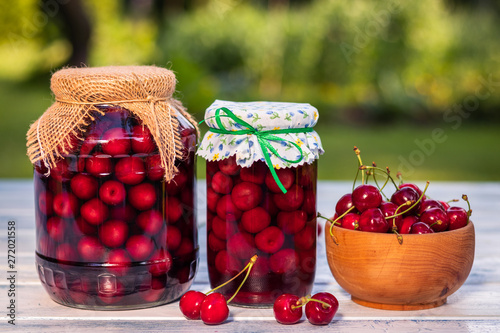 Quadro em tela Homemade cherry fruit compote in jar and harvested red cherries in bowl