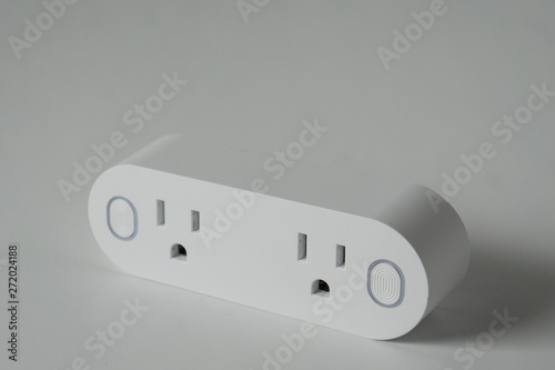 This double smart WIFI plug outlet can switch an electric device on or off via wi-fi. Isolated on a horizontal white background with copyspace or empty room space for text or copy.
