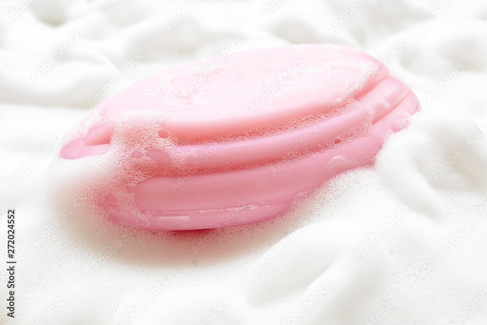 Pink soap on foam bubbles background. Pink soap on foam bubbles background.