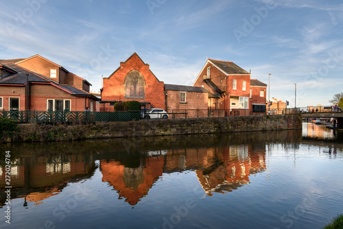 Reflection of houses in River Dee, Chester, UK.