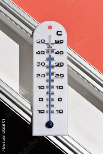 Thermometer that shows 40 grados celsius (104 º Farenheit) on a window's frame during a heat wave