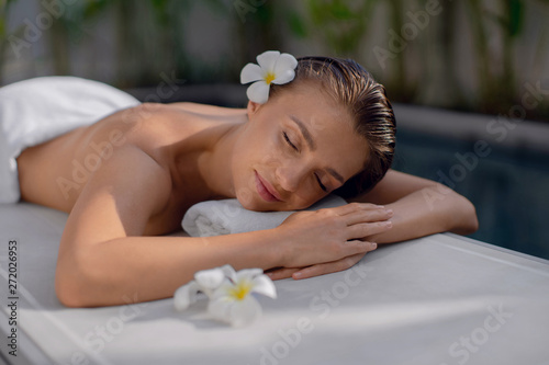 Beautiful girl relaxes around the pool. Spa