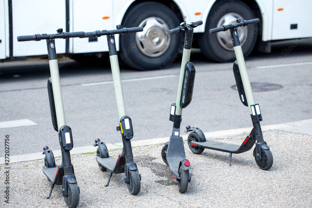 Modern сity transport - Four electric scooters is parked on the street of the city.