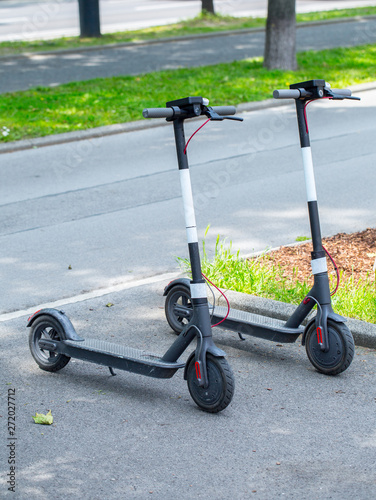 Modern сity transport - Two electric scooters is parked on the street of the city