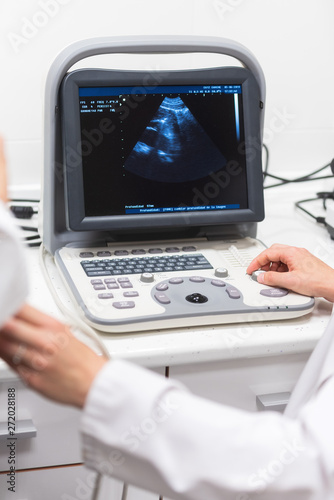 Ultrasound scanner in the hands of a doctor. Diagnostical Sonography clinic . 