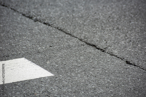 Asphalt with a pedestrian crossing and a crack