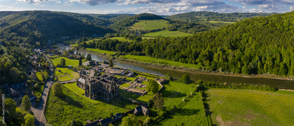 Aerial panoramic view of the ruins of Tintern Abbey, a Cistercian monastry located by the river Wye in South Wales, UK