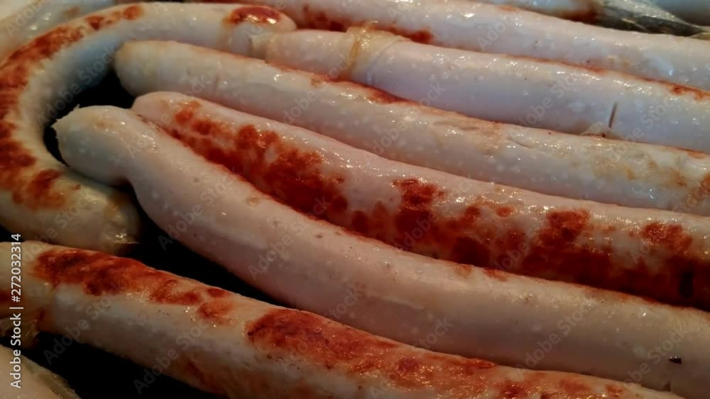 Rotating view of delicious sausages cooking on hot barbecue. Rotating view of delicious sausages cooking on hot barbecue.