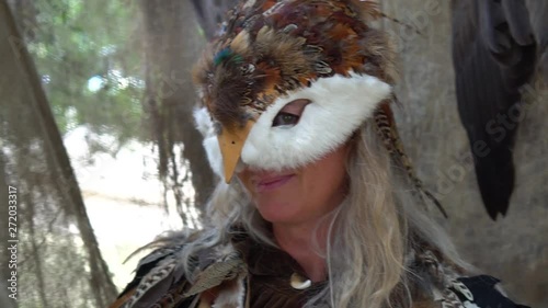 Woman dressed up as an owl smiles into the camera the camera slides photo
