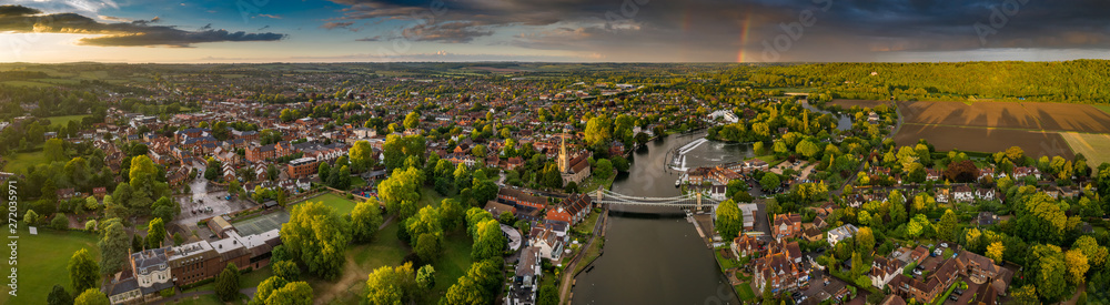 Dramatic aerial panoramic view of the beautiful town of Marlow in Buckinghamshire UK, captured after a rain storm, with a rainbow on the horizon - obrazy, fototapety, plakaty 