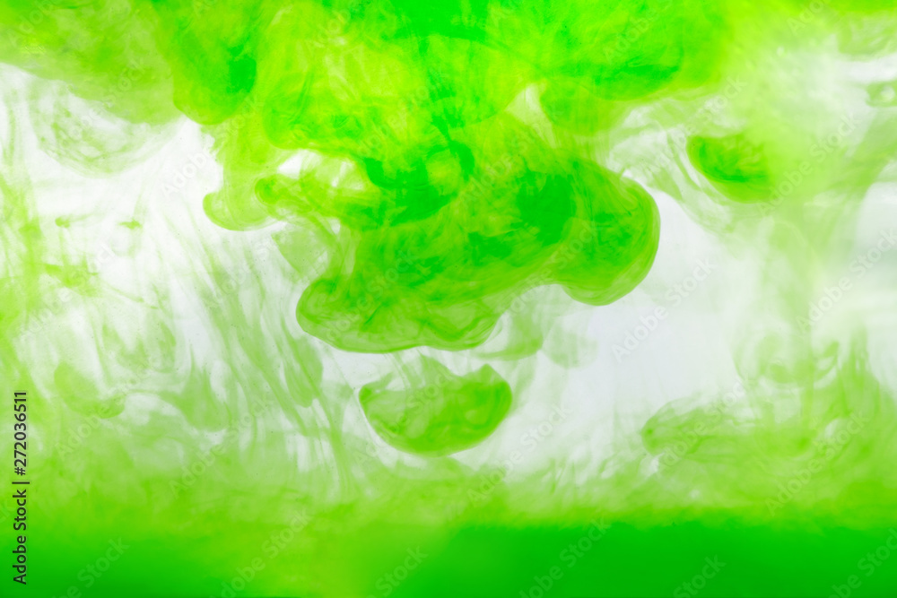 Fototapeta premium background of green ink diluted in water on white background