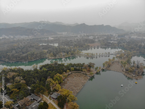 Aerial view little pavilions next the lake inside the Imperial Summer Palace of The Mountain Resort in Chengde. China. Chinese ancient building with lake and old style boat. UNESCO World Heritage. photo