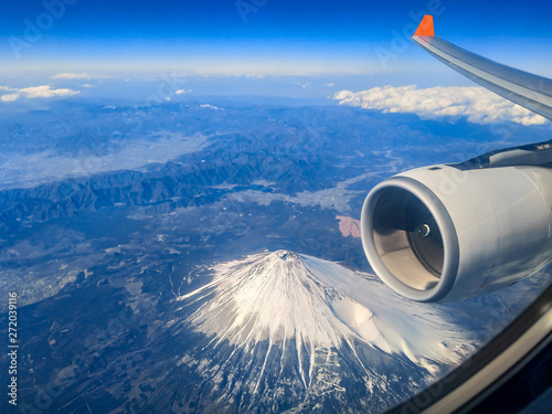 During the morning journey on the plane, the top view from the plane's window overlooking mount fuji in Japan