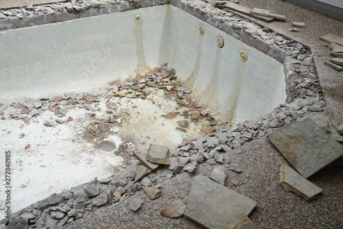 Empty swimming pool after demolishing old tile and coping for remodel