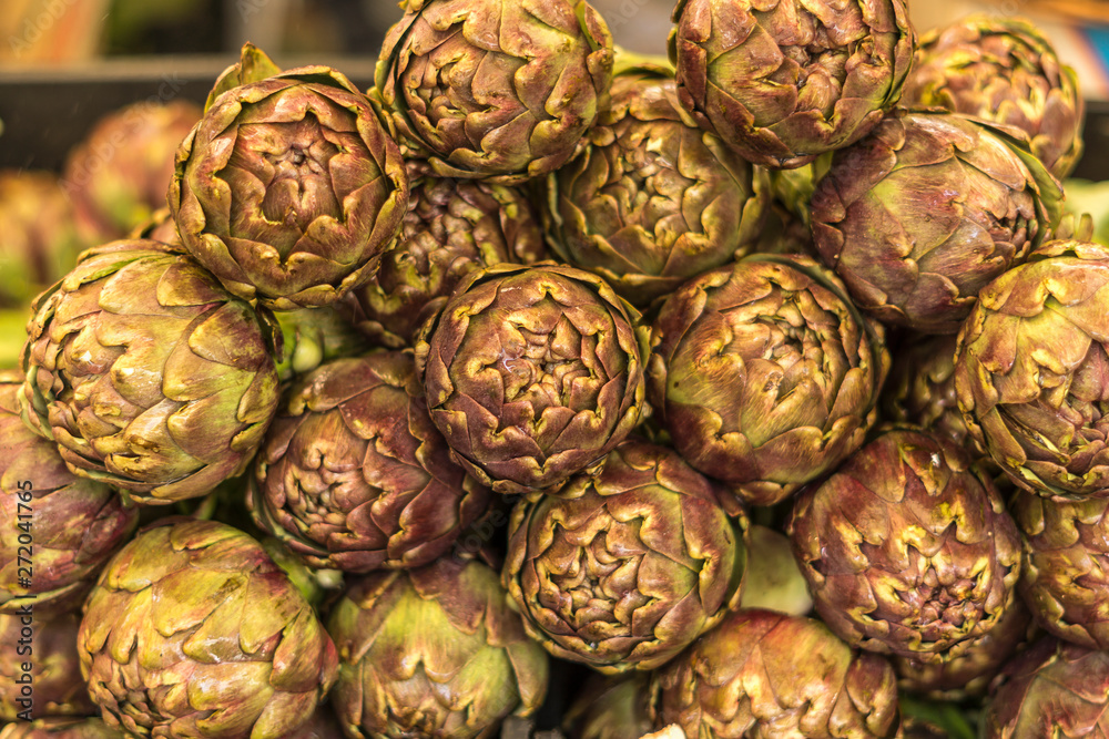 Fototapeta premium Close up of several fresh italian artichokes at fair