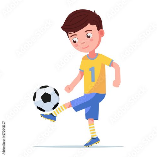 Boy soccer player kicking the ball on his leg
