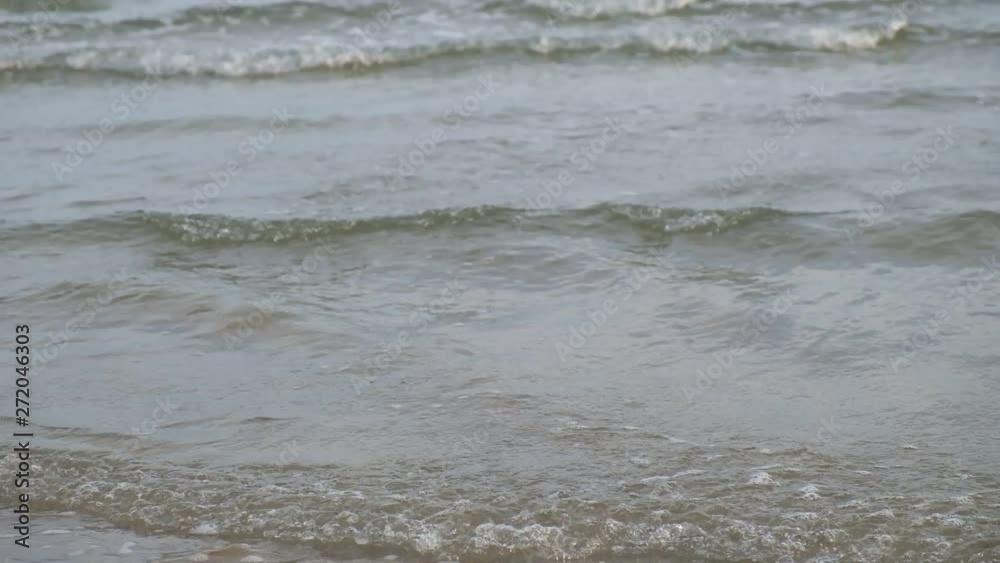 Slow motion, close up female walking along sandy beach background of ocean waves, in thailand Slow motion, close up female walking along sandy beach background of ocean waves, in thailand
