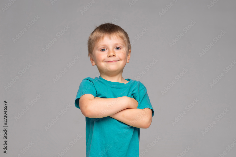 Portrait of happy smiling boy in blue t-shirt. Attractive kid in studio. Portrait of happy smiling boy in blue t-shirt. Attractive kid in studio.