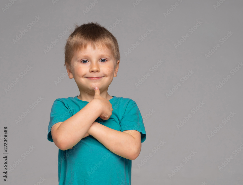 Portrait of happy smiling boy in blue t-shirt. Attractive kid in studio. Portrait of happy smiling boy in blue t-shirt. Attractive kid in studio.