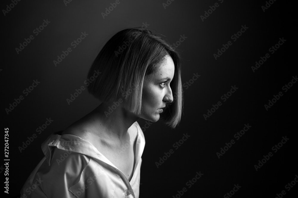 Dramatic black and white portrait of a beautiful woman on a dark background Dramatic black and white portrait of a beautiful woman on a dark background
