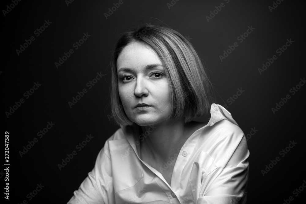 Dramatic black and white portrait of a beautiful woman on a dark background Dramatic black and white portrait of a beautiful woman on a dark background