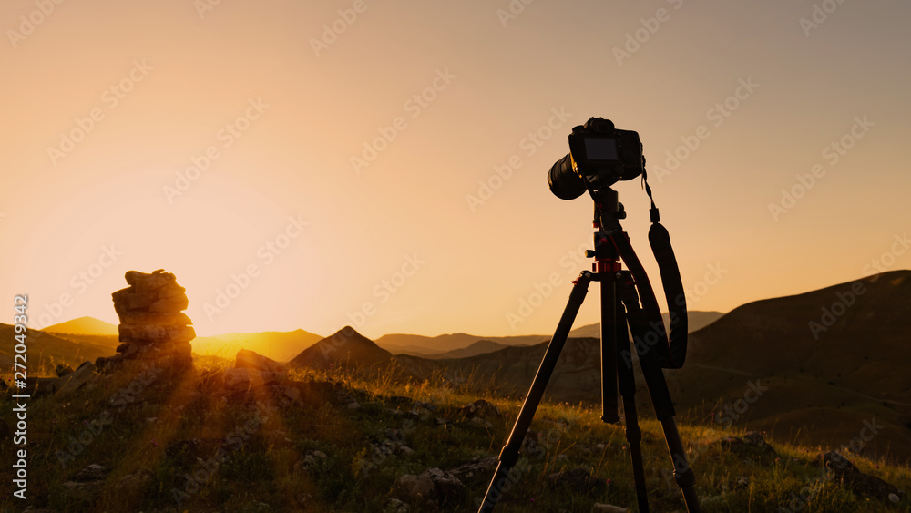 Camera on a tripod, shooting a sunset Camera on a tripod, shooting a sunset