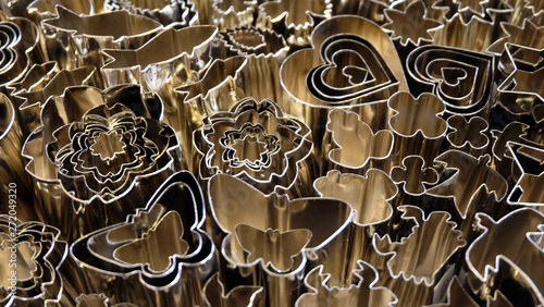 Closeup of a variety of metallic cooking cutters in different shapes.