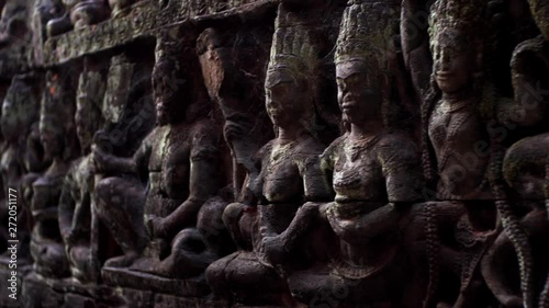 Extreme close view of detailed bas-reliefs of the Leper King terrace located in the northwest corner of the Royal Square of Angkor Thom, Cambodia. photo