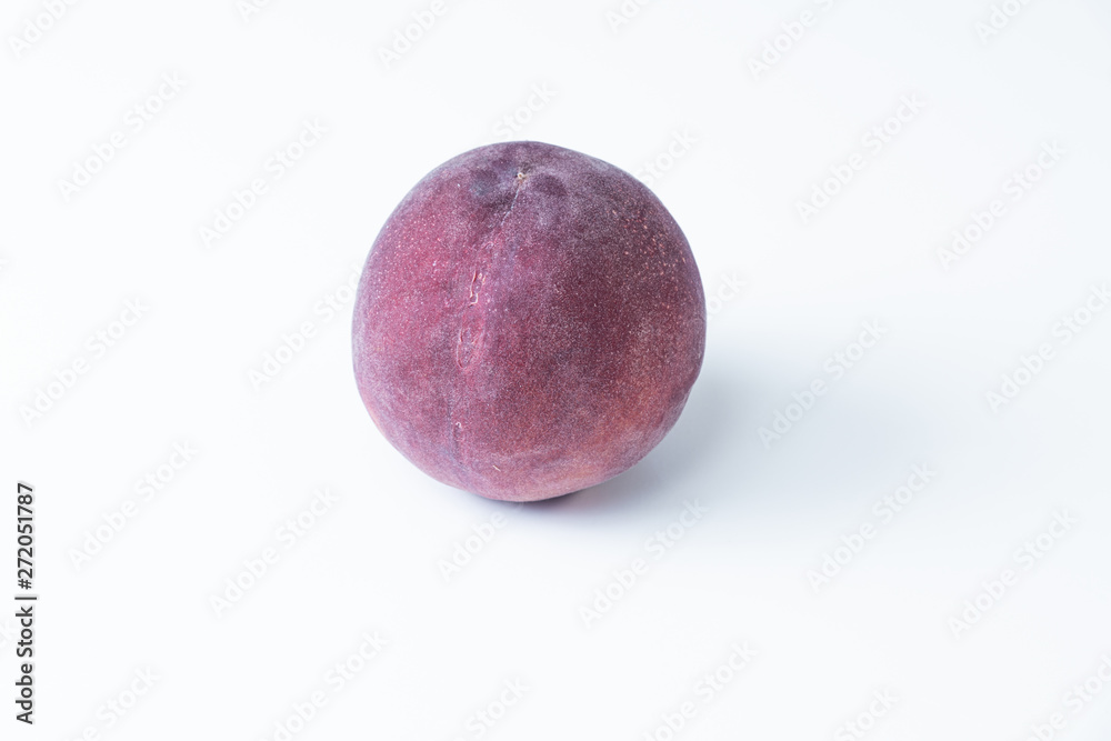 Top view of a purple nectarine on white background. Isolated isolated nectarine Top view of a purple nectarine on white background. Isolated isolated nectarine