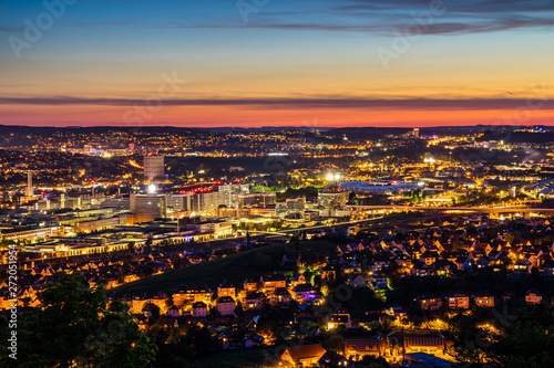 Germany, Illuminated skyline of downtown stuttgart city and arena of bad canstatt by night from above after sunset
