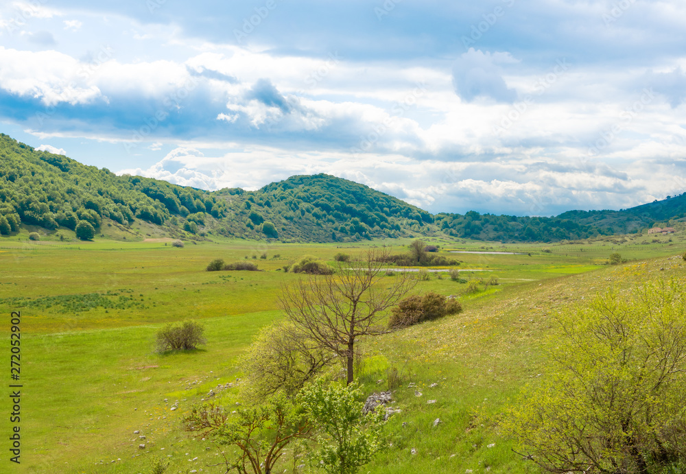 Fototapeta premium Altopiano di Rascino (Rieti, Italy) - The extended plateau of Rascino lake, over a thousand meters high, in the mountains between Lazio and Abruzzo region, province of Rieti, with spring flowering