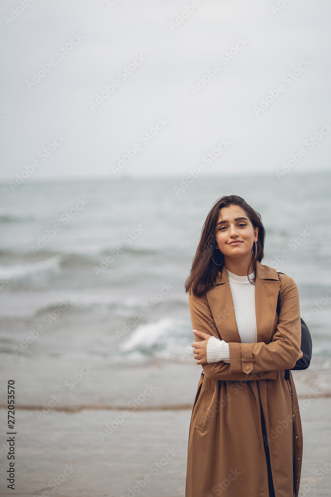 young girl walking on the beach during autumn young girl walking on the beach during autumn