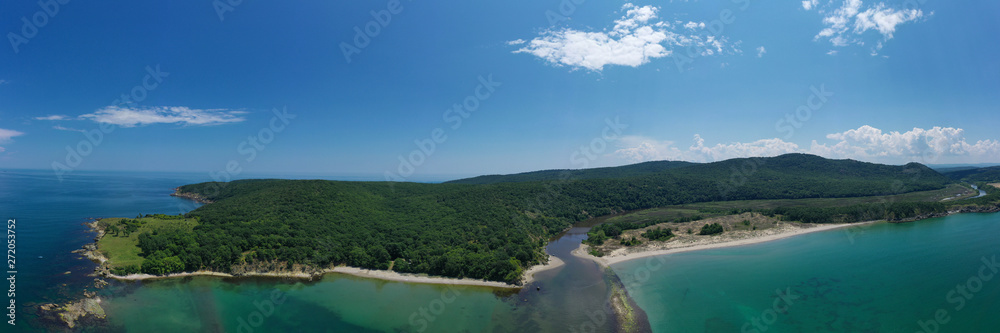 Panoramic aerial drone view of river flowing into the sea. Ropotamo river, Bulgaria