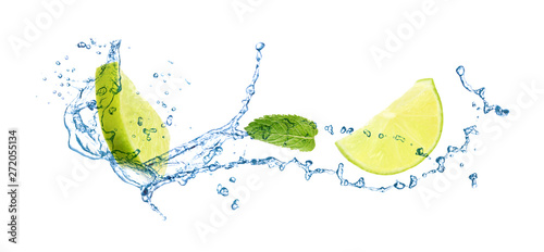 Slices of juicy lime  fresh mint and splashing cold water on white background