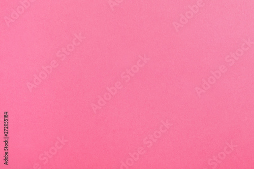 Pink paper sheet as color background, top view