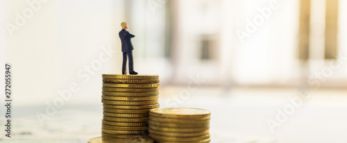 Leader businessman suits stand among stack of coin and money. Financial banner concept. photo