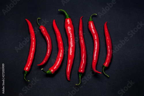 spicy red peppers on black background