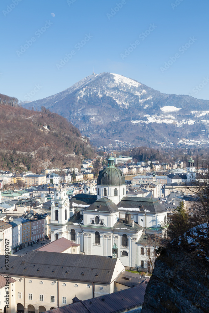 The view across Salzburg's Old Town in Austria.  In the foreground is Collegiate Church and in the background is Gaisberg a mountain to the East of the city.