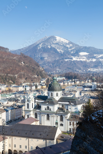 The view across Salzburg s Old Town in Austria.  In the foreground is Collegiate Church and in the background is Gaisberg a mountain to the East of the city.