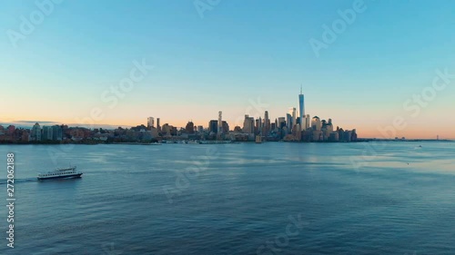 Aerial view of Manhattan at dawn.  New York City skyline, view from Hoboken. Drone flying over Hudson River, Ferry transportation