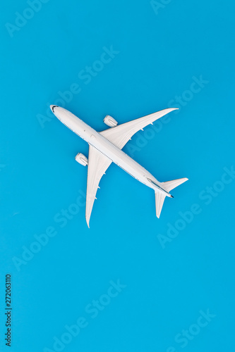 Model airplane on blue pastel color background,Top view