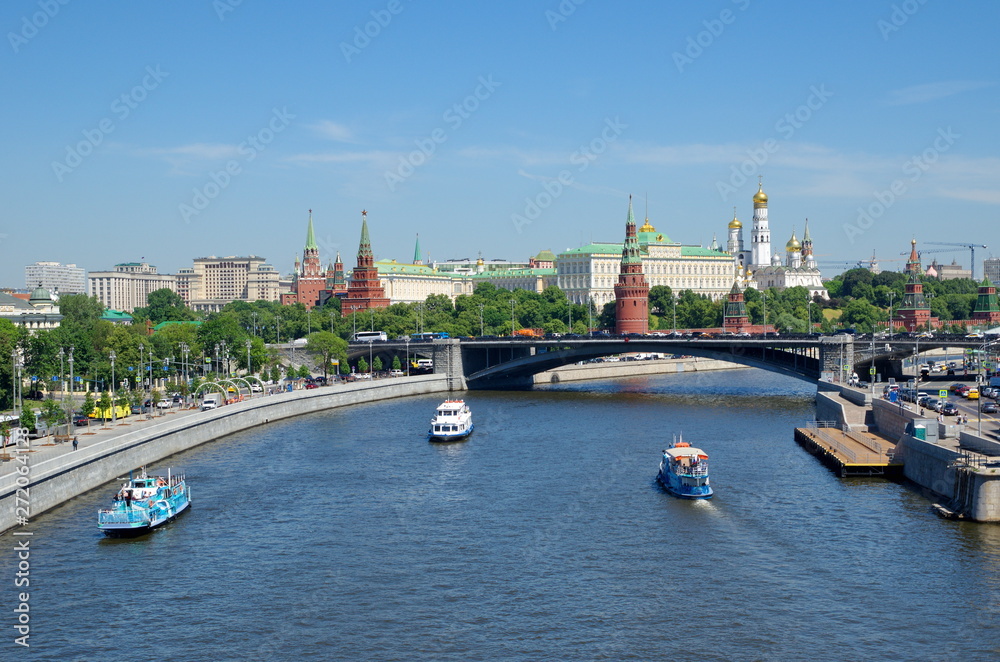 Summer view of the Moscow Kremlin, Prechistenskaya, Bersenevskaya embankments and pleasure boats. Moscow, Russia