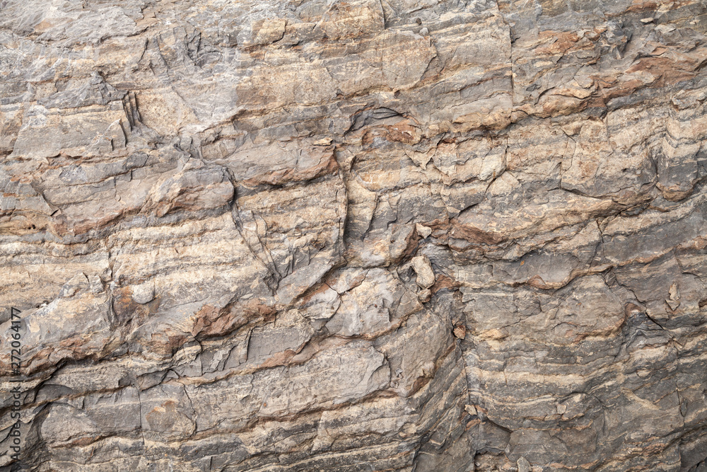 Rough brown stone wall, natural rock